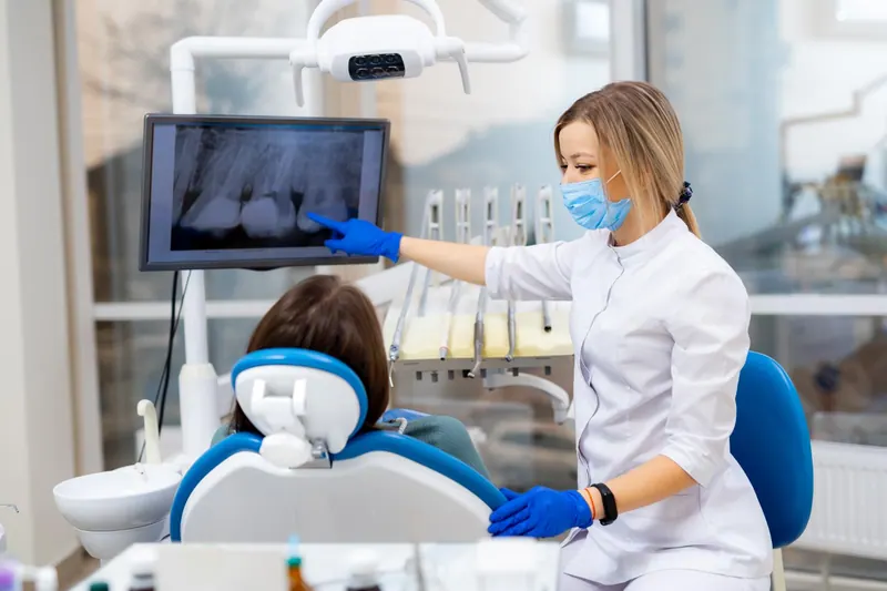 Dental professional explaining an X-ray to a patient